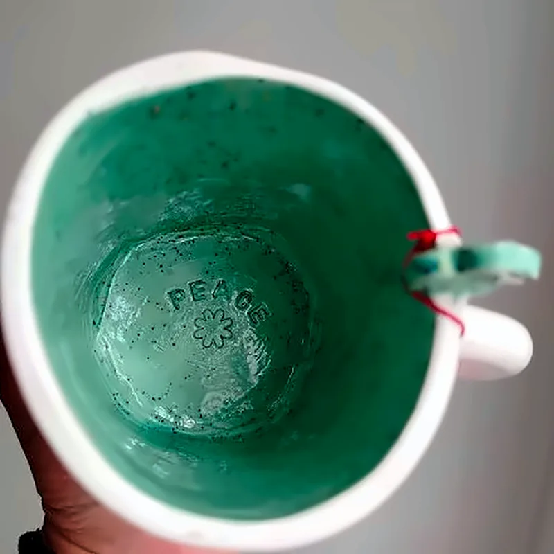 Taza blanca de cerámica con Hello you grabado e interior verde, otra vista 1